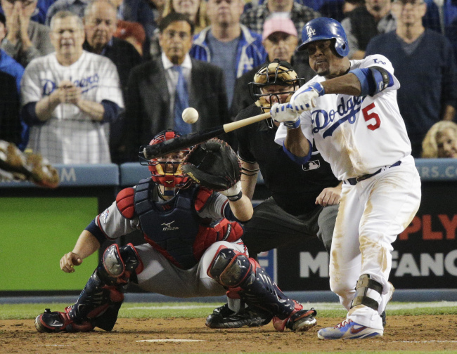 Los Angeles Dodgers` Juan Uribe hits a two-run home run as Atlanta Braves catcher Brian McCann and home plate umpire Bill Miller watch, during the eighth inning of Game 4 in the National League baseball division series Monday. (AP-Yonhap News)