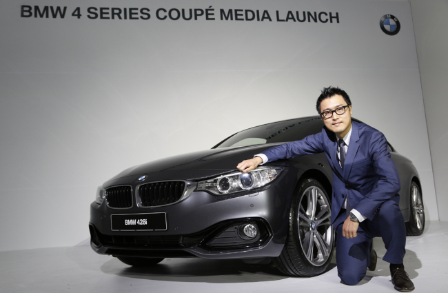 BMW designer Kang Won-kyu poses with a BMW 4 Series Coupe at a gallery in Paju, Gyeonggi Province on Thursday. (BMW Korea)