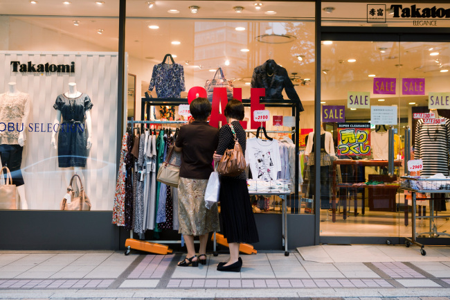 Women browse clothing outside a Takatomi store in the Ginza area of Tokyo. (Bloomberg)