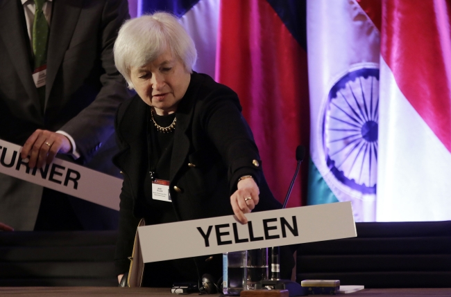 Janet Yellen, vice chair of the Board of Governors of the Federal Reserve System, places her nameplate at her seat at the International Monetary Conference in Shanghai on June 3. (AP-Yonhap News)