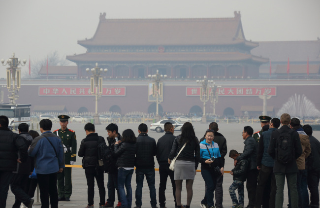 People wait in line for Tiananmen Square to open in Beijing. (Bloomberg)