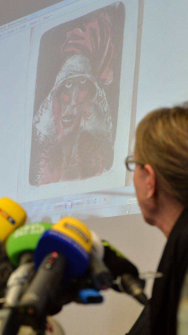 Art historian Meike Hoffmann from the Berlin Free University looks at a projected painting of Otto Dix during a news conference on the art found in Munich, in Augsburg, southern Germany, Nov. 5. (AP-Yonhap News)