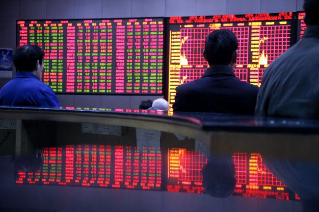 Investors monitor and trade stocks at a securities exchange in Shanghai. (Bloomberg)