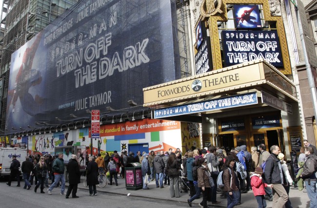 In this March 9, 2011 file photo, people line up to enter the Foxwoods Theatre for a matinee showing of “Spider-Man: Turn Off the Dark,” in New York. (AP-Yonhap News)