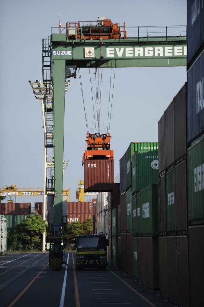 A container is loaded onto a truck at a shipping terminal in Tokyo on Wednesday. (Bloomberg)