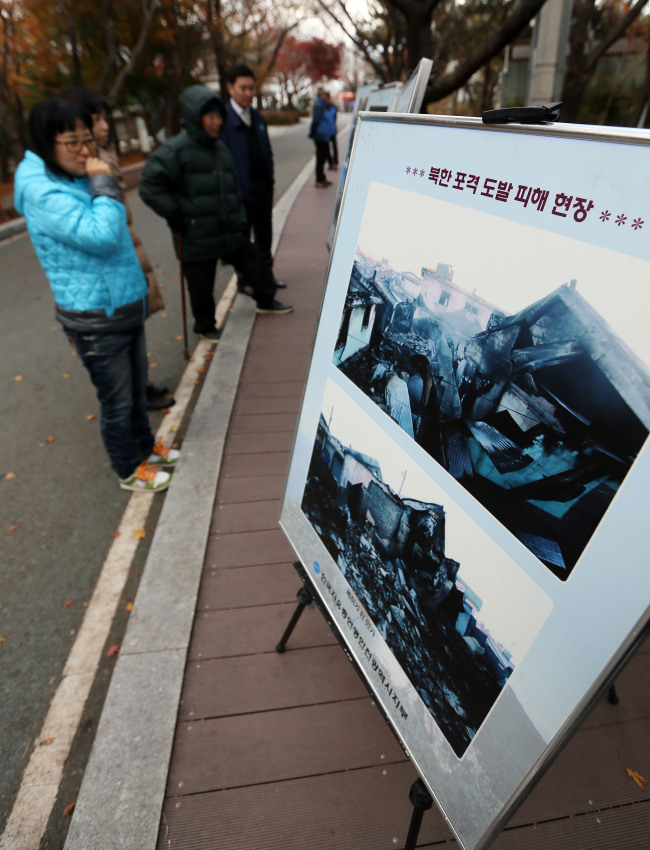A photo exhibition is held to mark the third anniversary of North Korea’s shelling of Yeonpyeongdo Island at a park in Incheon on Tuesday, four days before the national commemoration of the attack. (Yonhap News.)