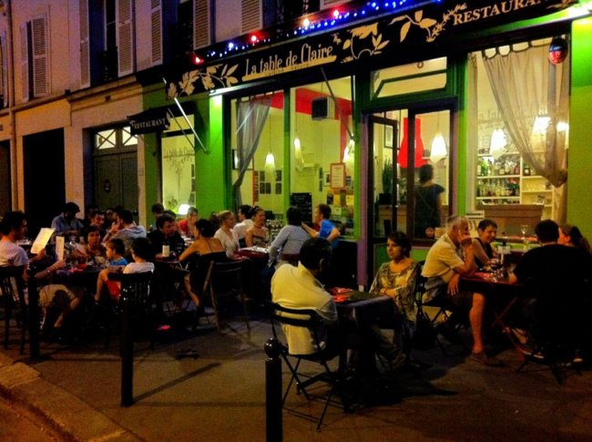 Patrons dine on the sidewalk in front of Le Table de Claire restaurant, located on the ground floor of the home swap apartment recent visitors stayed in while in Paris. (Los Angeles Times/ MCT)