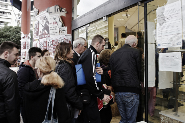 Job seekers pass through the doors of an OAED employment center soon after it opened in Thessaloniki, Greece. (Bloomberg)