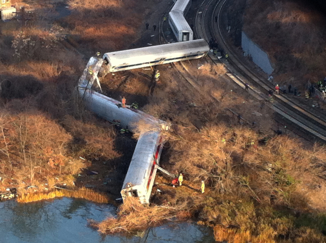 Cars from a Metro-North passenger train are scattered after the train derailed in the Bronx neighborhood of New York, Sunday, Dec. 1, 2013. The Fire Department of New York says there are 