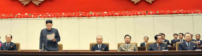 North Korean leader Kim Jong-un (left) is seen with his top aides including his uncle Jang Song-thaek (right) at a meeting on Jan. 28. (Yonhap News)