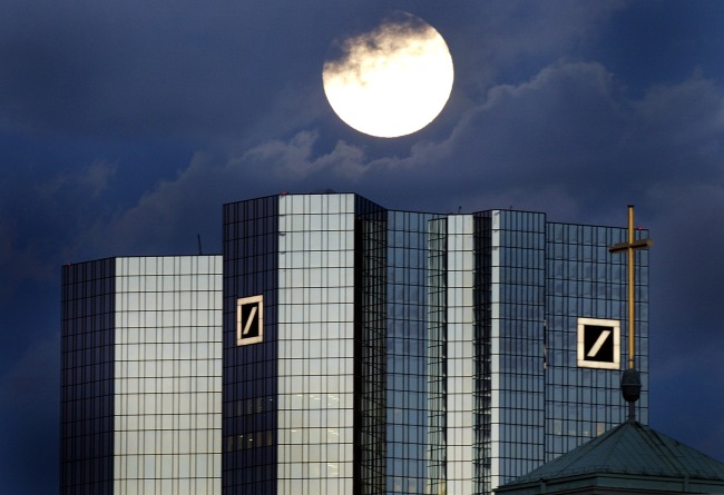 A rising full moon is seen over the twin towers of the Deutsche Bank headquarters in Frankfurt. (Bloomberg)