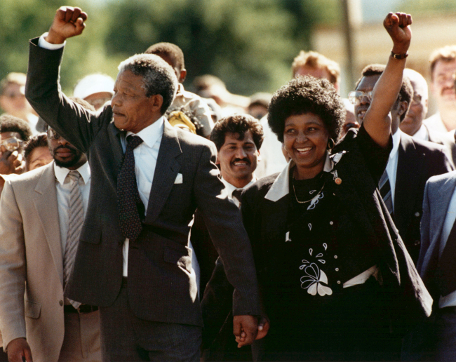 In this Feb. 11, 1990 file photo, Nelson Mandela, left, and his wife, Winnie, walk out of the Victor Verster prison in Paarl, near Cape Town, South Africa, after Mandela had spent 27 years in jail. (AP-Yonhap News)