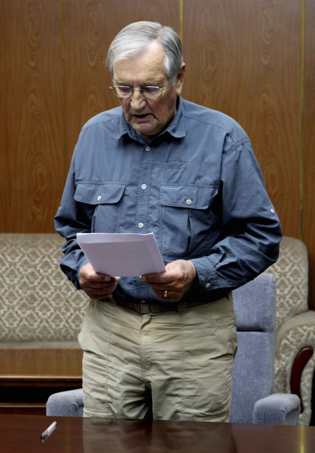 Merrill Newman, 85, reads a document, which North Korean authorities say was an apology that Newman wrote and read in North Korea. North Korea said Saturday Dec. 7, 2013, that it has deported the elderly U.S. tourist and war veteran detained for more than a month for alleged hostile acts against the country. (AP)