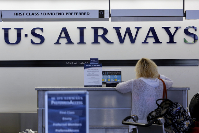 A traveler checks in for a US Airways Group Inc. flight at Los Angeles International Airport in Los Angeles, California. (Bloomberg)