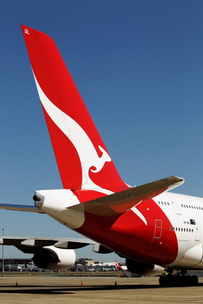 The Qantas Airways Ltd. logo is displayed on the tail of an aircraft in Sydney. (Bloomberg)