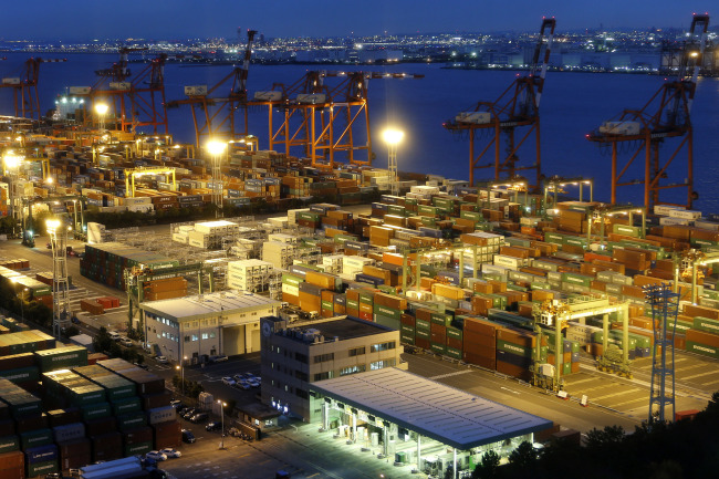 Containers are stacked at a shipping terminal in Tokyo. (Bloomberg)