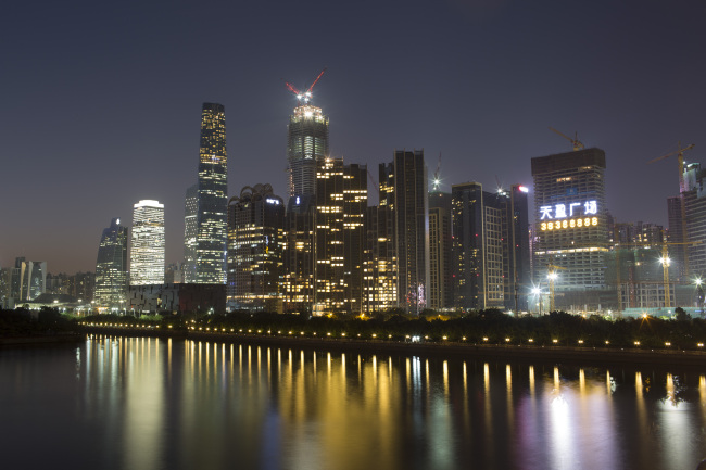 Buildings stand illuminated at dusk in the Zhujiang New Town district of Guangzhou, China. (Bloomberg)