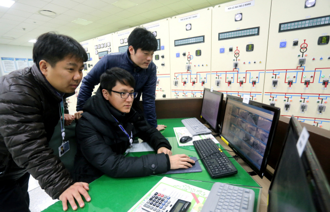 Engineers from Samsung Electronics examine power usage at the energy monitor room of its Digital City in Suwon on Sunday. Samsung said it plans to install LED lighting throughout the whole Suwon campus by the end of next year as LED lighting is 25 to 40 percent more energy-efficient than general lighting. (Samsung Electronics)