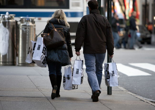 Shoppers carry bags outside of a Saks Fifth Avenue department store in New York. (Bloomberg)