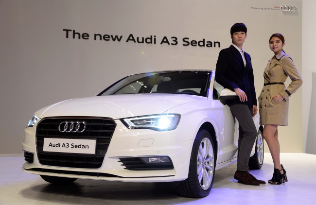 Models pose with the Audi A3 sedan unveiled at a launching event at Coex in southern Seoul on Monday.(Park Hae-mook/The Korea Herald)