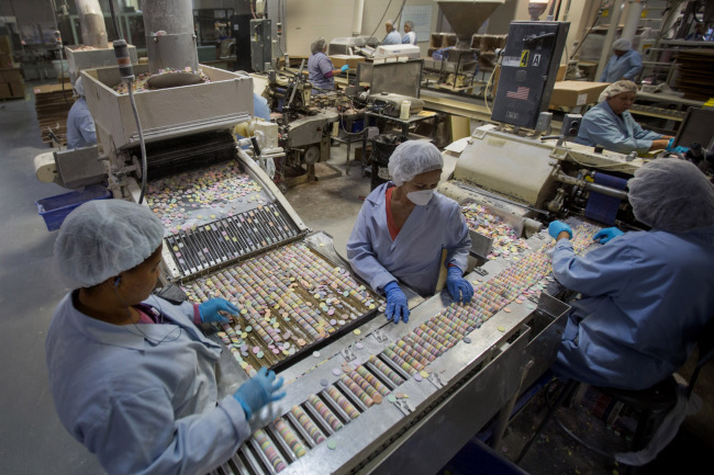 Workers sort “Necco Wafers” at the New England Confectionery Co. in Revere, Massachusetts. (Bloomberg)