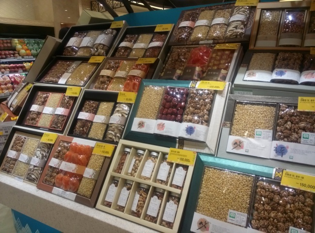 Various holiday gift boxes are lined up on a shelf at Shinsegae Department Store in Seoul on Friday. (Suk Gee-hyun/The Korea Herald)