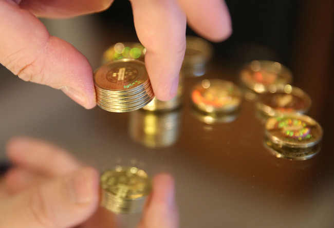 A man stacks Bitcoins in Sandy, Utah. (Bloomberg)