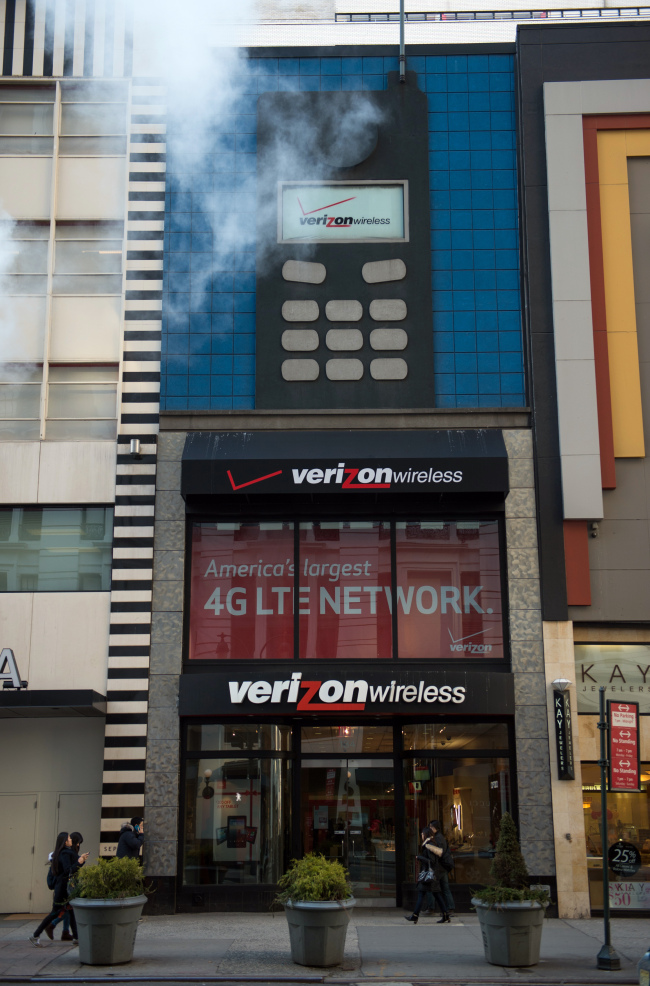 Pedestrians walk past a Verizon Wireless store in New York. (Bloomberg)