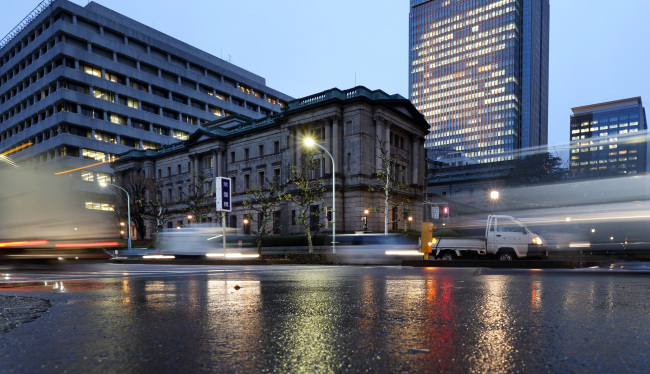 Traffic moves past the Bank of Japan headquarters in Tokyo. (Bloomberg)