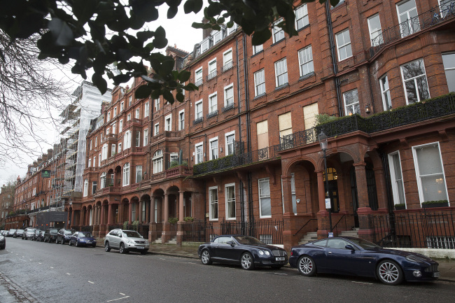 Automobiles sit parked in front of residential properties on Cadagon Square in London. (Bloomberg)