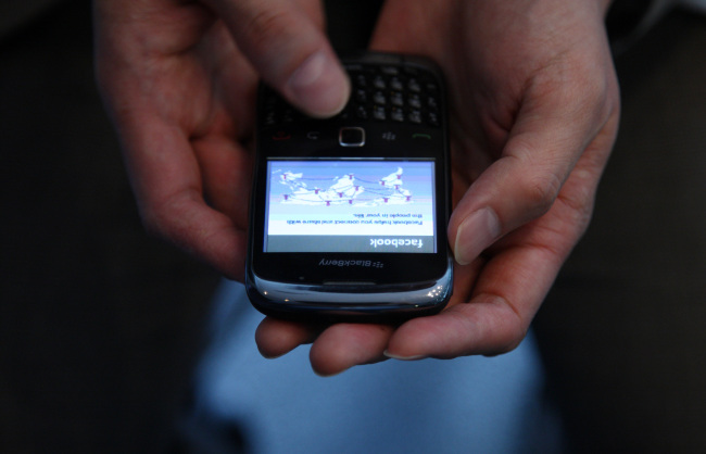 The Facebook website is displayed on a Blackberry 9900 smartphone in Tokyo. (Bloomberg)