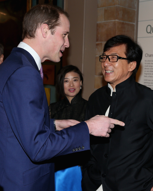 Prince William (left), Duke of Cambridge, meets actor Jackie Chan as he arrives at an evening reception for the Illegal Wildlife Trade conference at the Natural History Museum in London on Wednesday. (AP-Yonhap)