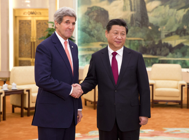 U.S. Secretary of State John Kerry (left) meets with Chinese President Xi Jinping at the Great Hall of the People in Beijing on Friday. (AP-Yonhap)