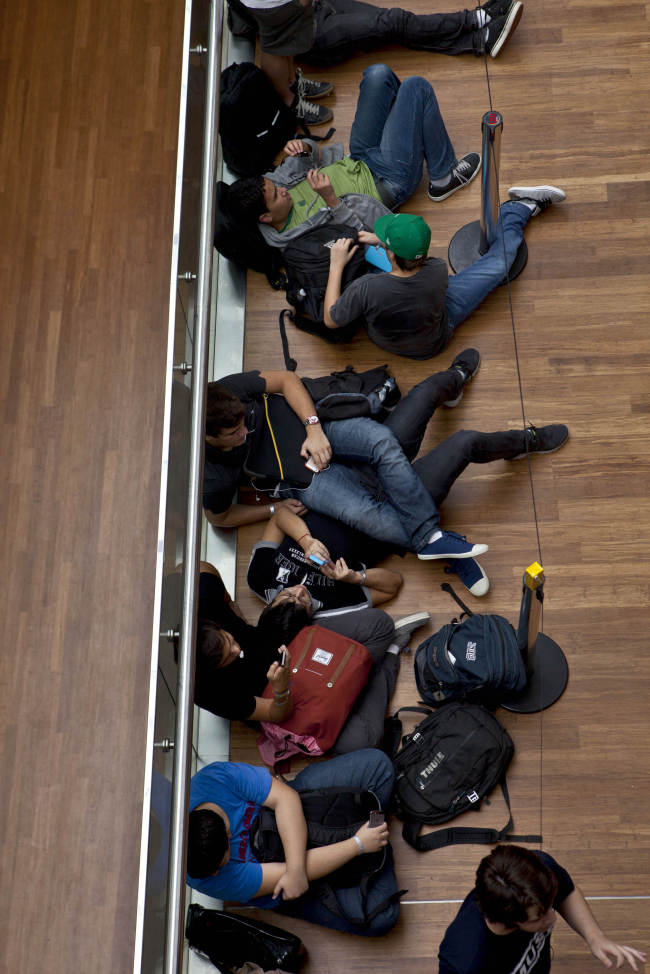 Customers wait in line for the opening of the first Apple Inc. store in Latin America, at the Village mall in Rio de Janeiro, Brazil, Saturday. (Bloomberg)