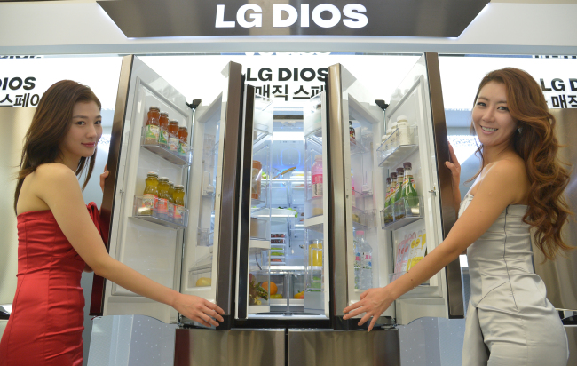 Models showcase LG Electronics’ Double Magic Space refrigerator that boasts enhanced storage space.(Yoon Byung-chan/The Korea Herald)