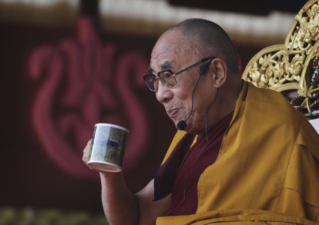 Tibetan spiritual leader the Dalai Lama sips tea during his sermons at a five-day festival of Tibet, in Gauhati, India, earlier this month. (AP)