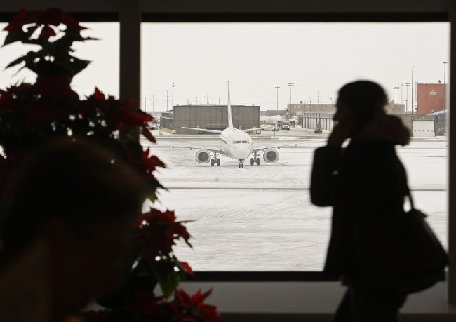 A passenger talks on her phone as she makers her way to her flight at Salt Lake City International Airport in Salt Lake City, Utah. (Bloomberg)