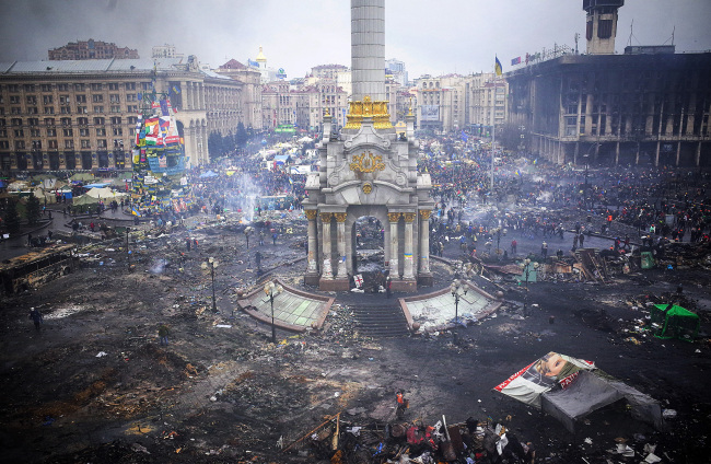 Protestors inspect damage caused by recent anti-government protests on Independence Square following recent clashes in Kiev, Ukraine, on Thursday. (Bloomberg)