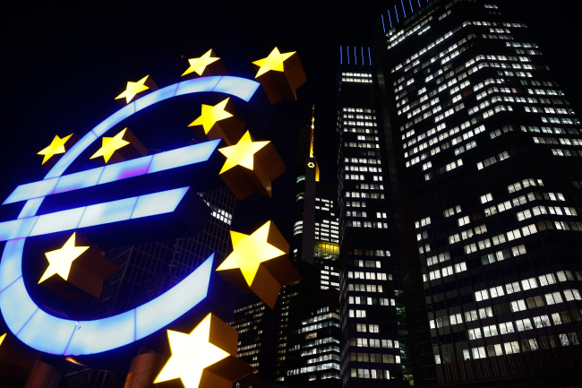 An illuminated euro sign sculpture stands outside the headquarters of the European Central Bank in Frankfurt, Germany. (Bloomberg)