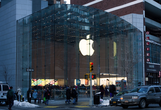 Pedestrians pass in front of an Apple Inc. store in New York. (Bloomberg)