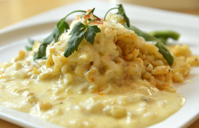 Edelweiss’ handmade knopfli is served up robed in a rich Gruyere cheese sauce with green beans. (Yoon Byung-chan/The Korea Herald)