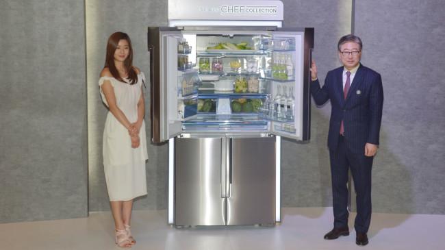 Samsung Electronics’ consumer electronics chief Yoon Boo-keun (right) poses with actress Jun Ji-hyun at Shilla Hotel to promote the company’s Chef Collection refrigerator, designed in collaboration with world-famous Michelin-starred chefs. (Kim Myung-sub/The Korea Herald)