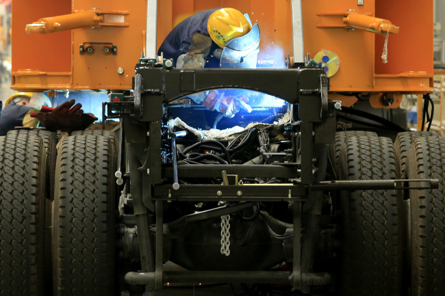 An employee welds during the manufacture of construction machinery in Sany Heavy Industry Co.’s assembly shop in Changsha, Hunan Province, China. (Bloomberg)