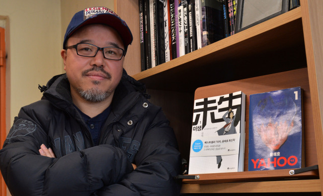 Webtoon writer Yoon Tae-ho poses in his office prior to an interview with The Korea Herald on March 7. (Lee Sang-sub/The Korea Herald)