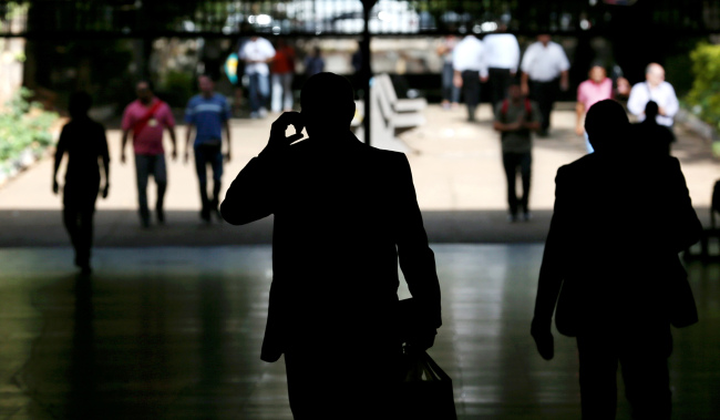 A man uses a mobile phone while walking through an underground mall in a banking district in Brazil. (Bloomberg)