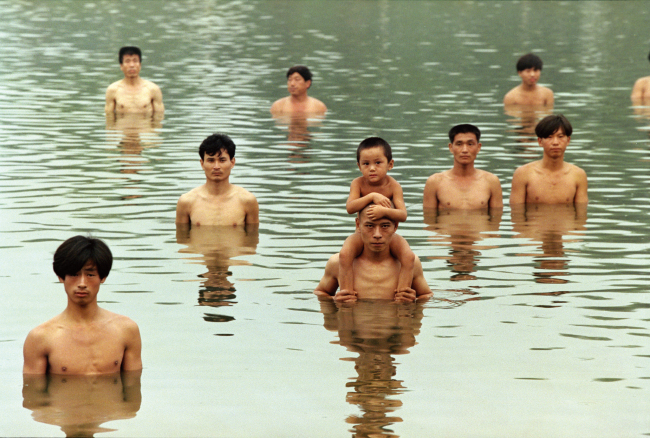 A still image from the film “To Raise the Water Level in a Fishpond” by Zhang Huan. (Total Museum)