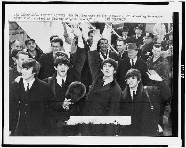 Front row, from the left: The Beatles member John Lennon, Paul McCartney, George Harrison and Ringo Starr wave hands at the fandom in John F. Kennedy Airport in New York, U.S., February 1964. (Wikimedia)
