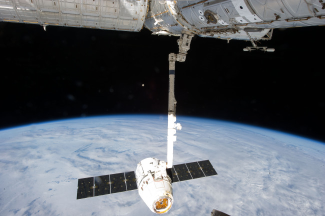 This March 26, 2013, file photo shows the release of the SpaceX Dragon-2 spacecraft from the International Space Station. (AP-Yonhap)