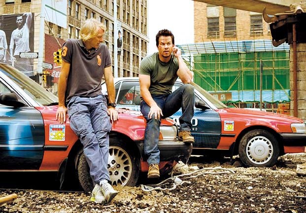 This image released by Paramount Pictures shows director Michael Bay (left) with Mark Wahlberg on the set of “Transformers: Age of Extinction.” (AP)