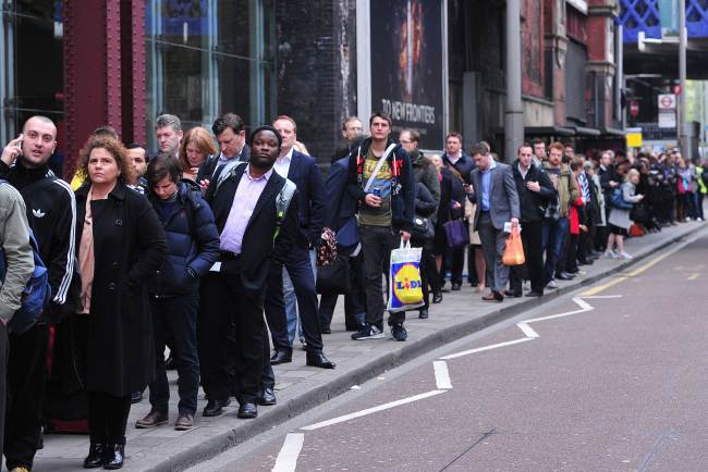 Commuters line up for buses outside Waterloo Station in London on Tuesday. (AFP-Yonhap)